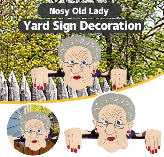 Quirky garden fence art decoration featuring an elderly couple peeking over a fence