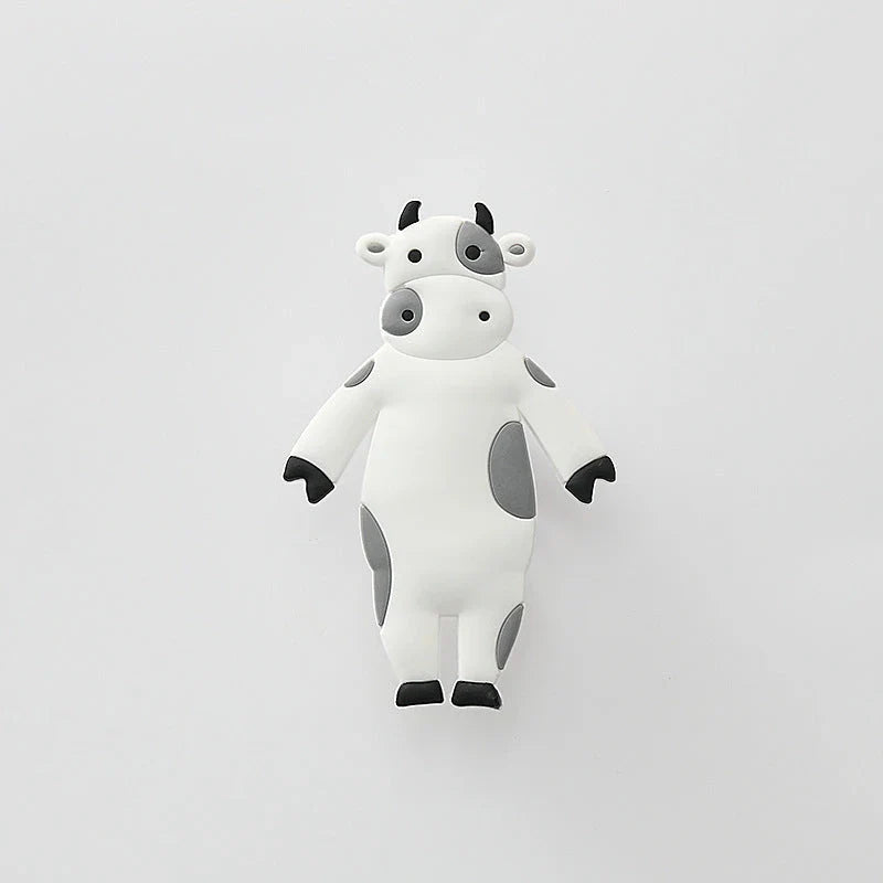 Assorted animal-shaped wall hooks in various colours, including bear, zebra, and cow designs, displayed on a white background