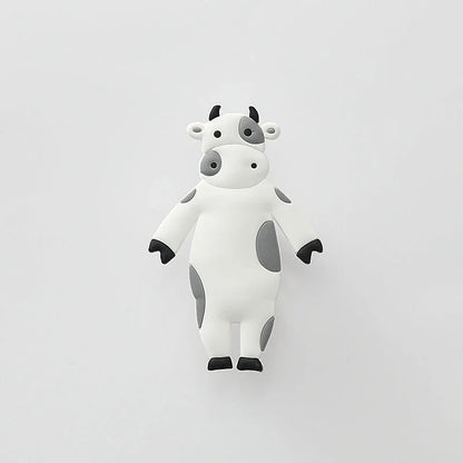 Assorted animal-shaped wall hooks in various colours, including bear, zebra, and cow designs, displayed on a white background