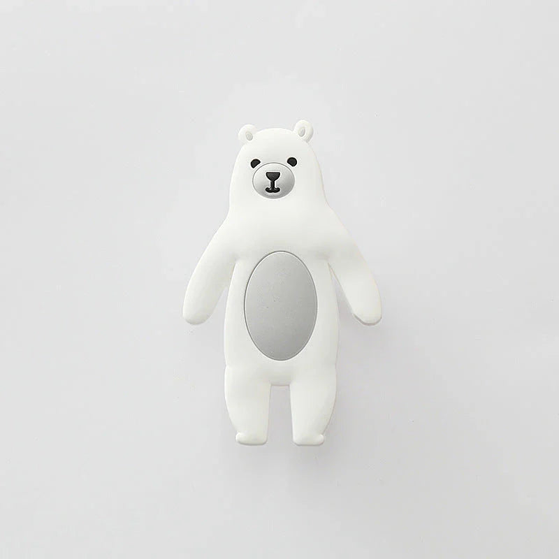 Assorted animal-shaped wall hooks in various colours, including bear, zebra, and cow designs, displayed on a white background