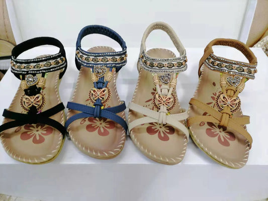 Women's flat sandals with flower rhinestone detail in black, royal blue, apricot, and brown