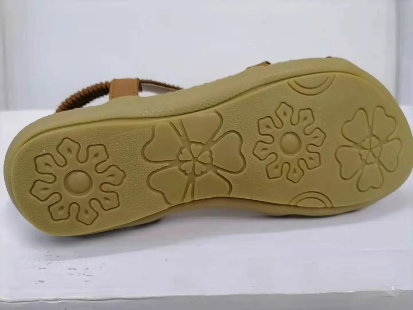 Women's flat sandals with flower rhinestone detail in black, royal blue, apricot, and brown