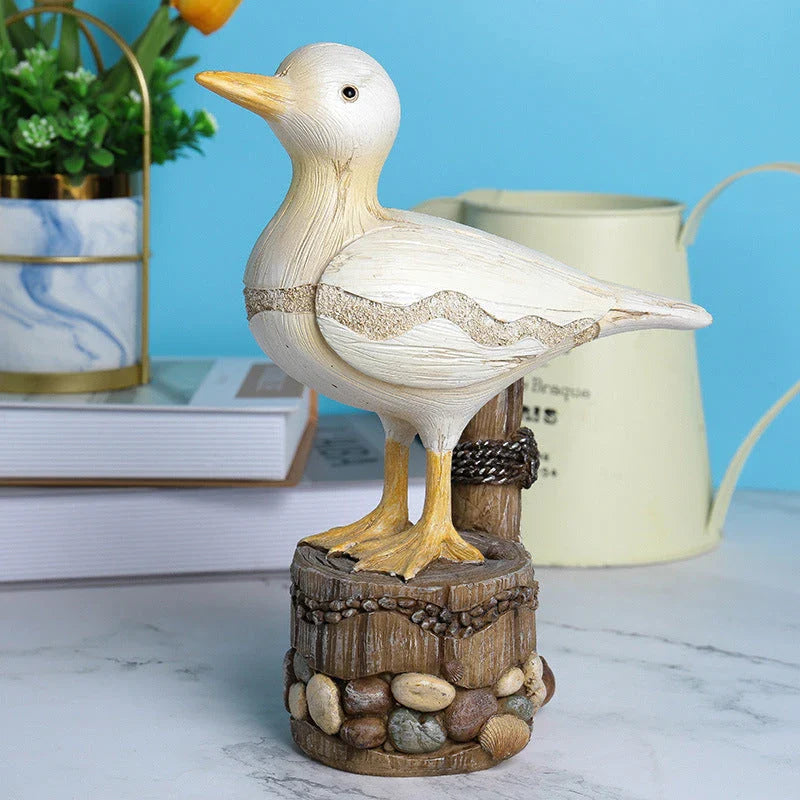 Resin seagull statue perched on a weathered wooden stump, bringing coastal charm to any indoor or outdoor space