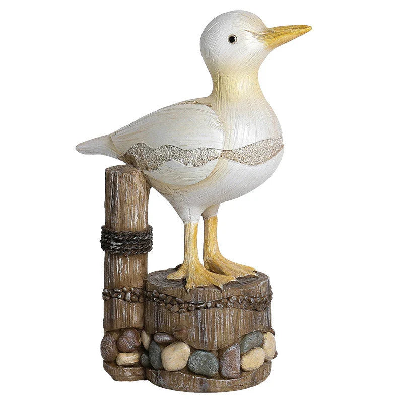 Resin seagull statue perched on a weathered wooden stump, bringing coastal charm to any indoor or outdoor space
