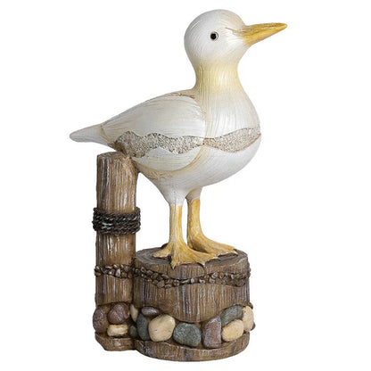 Resin seagull statue perched on a weathered wooden stump, bringing coastal charm to any indoor or outdoor space