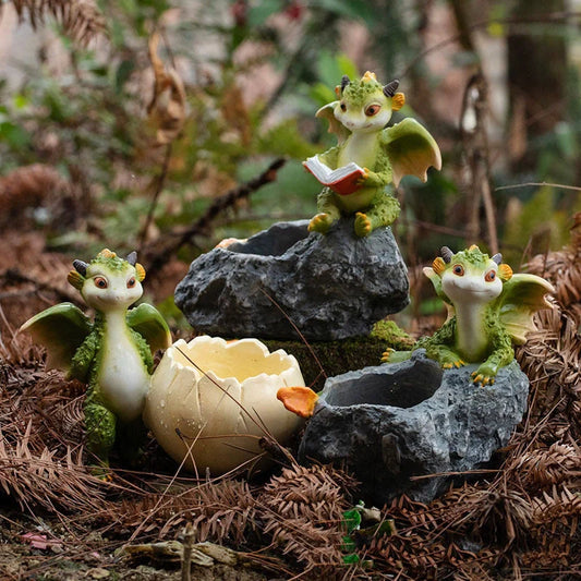 Hand-painted dinosaur succulent pots in three styles: Egg, Lying Stone, and Reading Dinosaurs