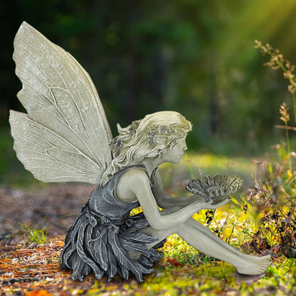 A beautiful resin fairy garden statue with a flower crown and petal skirt, holding a sunflower bowl to attract birds