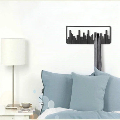 Wall-mounted coat rack with modern, artistic design and 5 flip-down hooks for storing coats, hats, scarves, and more
