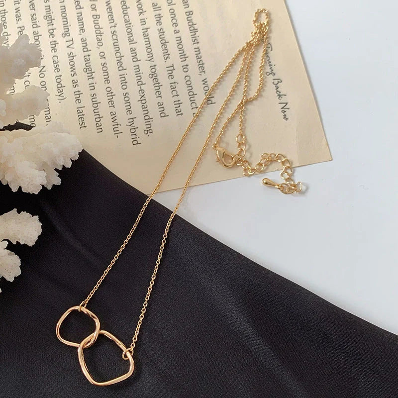 Gold alloy abstract face choker necklace with geometric pendant and adjustable chain