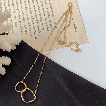 Gold alloy abstract face choker necklace with geometric pendant and adjustable chain