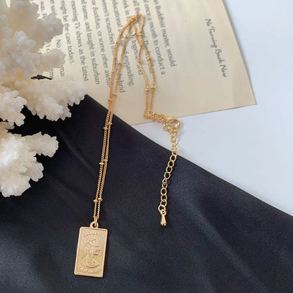 Gold alloy abstract face choker necklace with geometric pendant and adjustable chain
