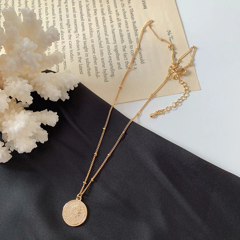 Gold alloy abstract face choker necklace with geometric pendant and adjustable chain