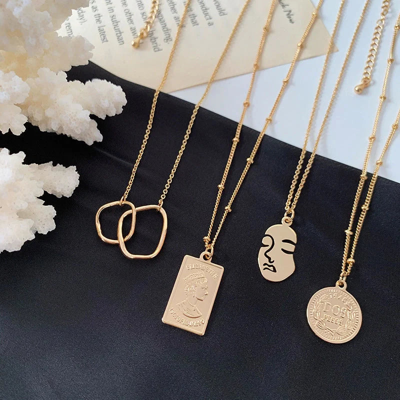 Gold alloy abstract face choker necklace with geometric pendant and adjustable chain