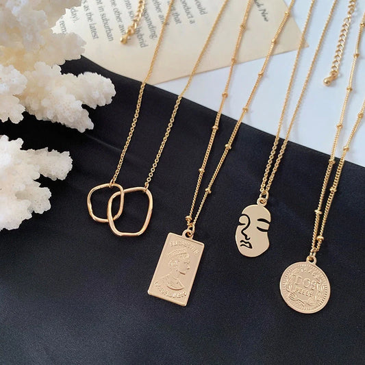 Gold alloy abstract face choker necklace with geometric pendant and adjustable chain