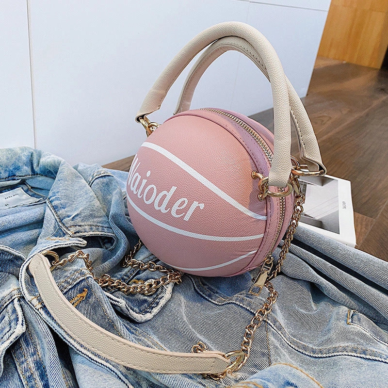 Basketball-shaped handbag in pink, white, black, or brown with adjustable chain shoulder strap
