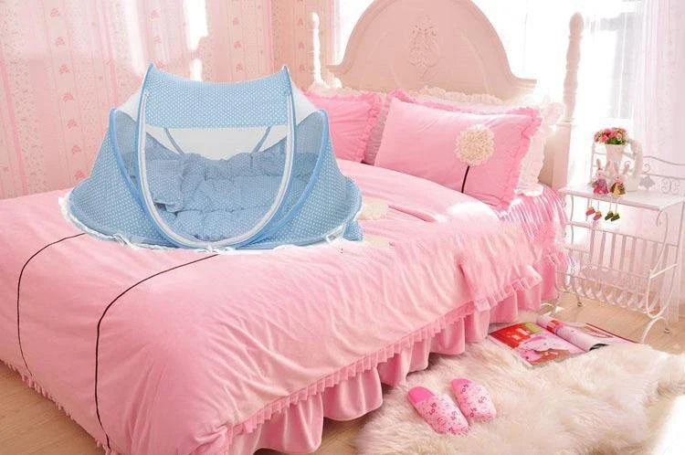 Foldable baby mosquito net bed with soft mattress and pillows, providing a safe and comfortable sleeping environment for infants and toddlers.