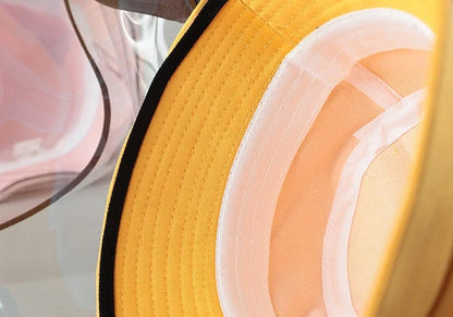 Child wearing anti-spitting protective hat with transparent bezel