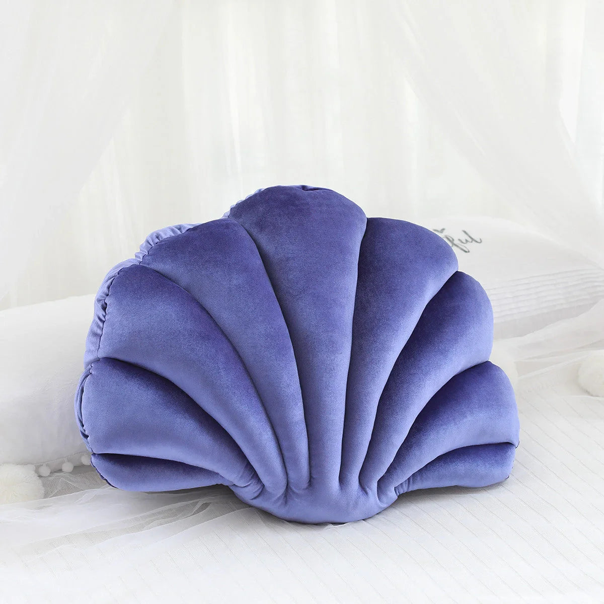 Cosy shell-shaped plush nap pillow in various colours and sizes for ultimate comfort