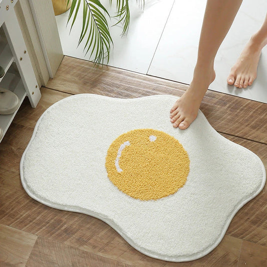 Quirky egg-shaped entrance mat made of absorbent polyester fabric with non-slip rubber backing, available in various sizes and colours