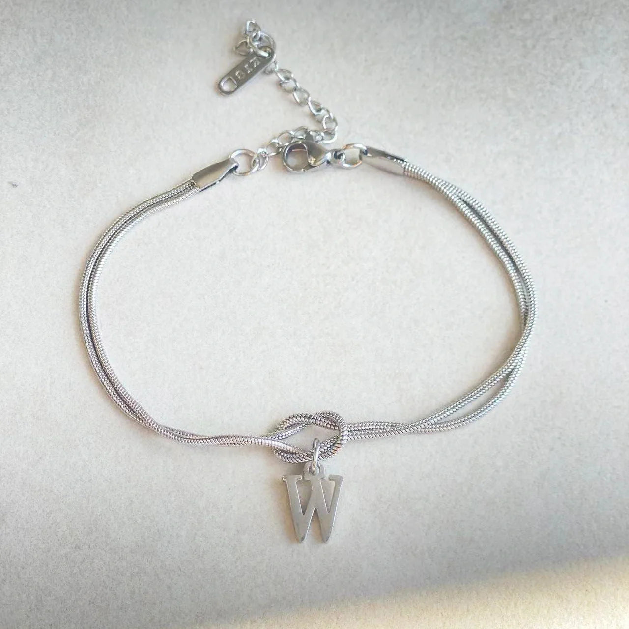 Personalised gold and silver love knot bracelets for couples, perfect as Valentine's Day gifts.