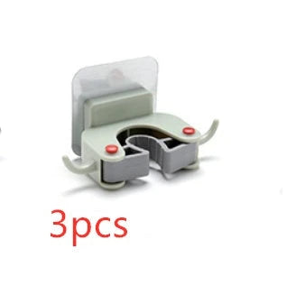 Adhesive wall-mounted mop and broom holder with double hooks for storing cleaning tools, available in multiple colors.