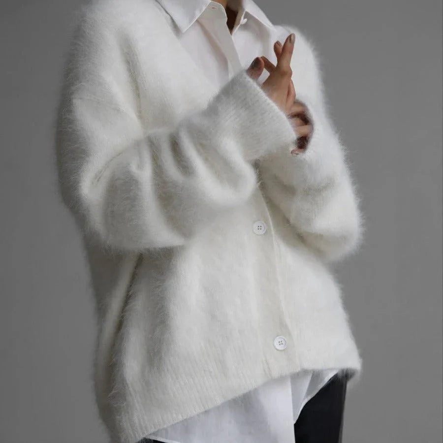 A stylish loose knit cardigan in a variety of colors, featuring a v-neck design and single-breasted closure for a flattering, relaxed fit.