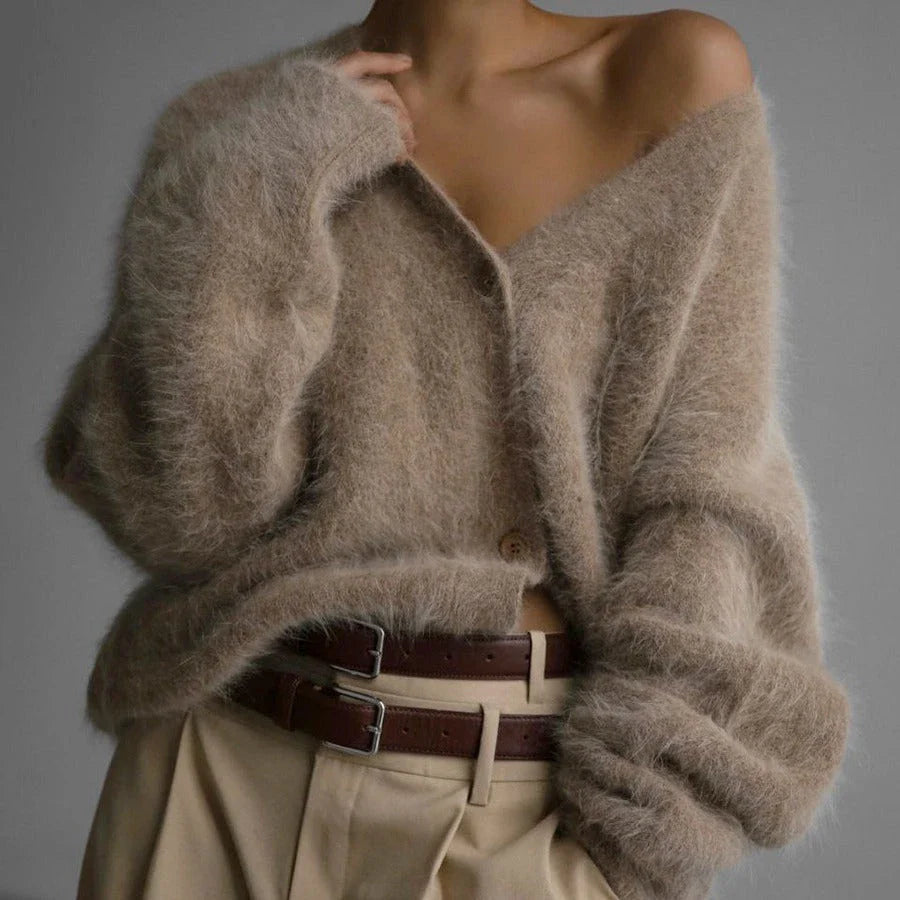 A stylish loose knit cardigan in a variety of colors, featuring a v-neck design and single-breasted closure for a flattering, relaxed fit.