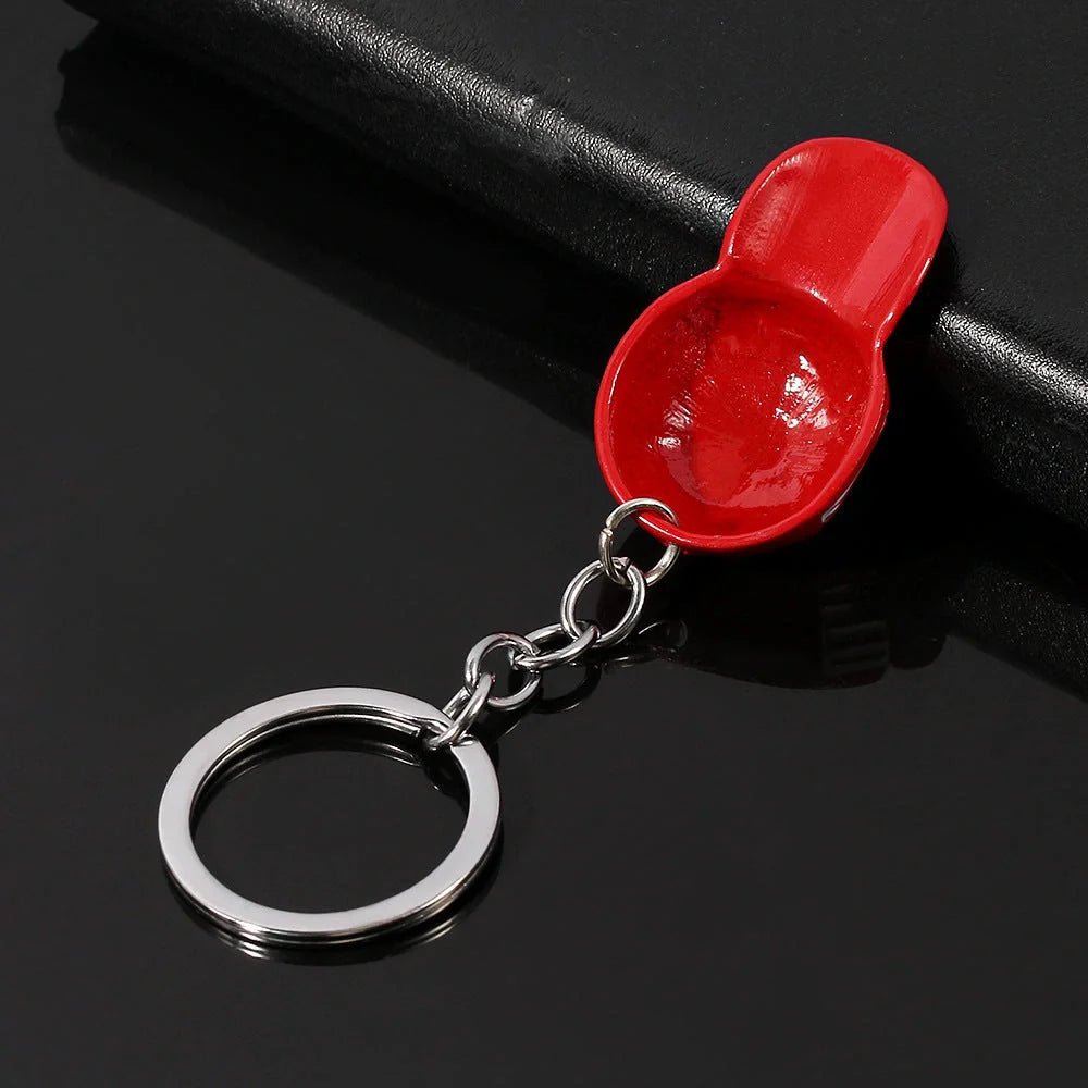 A vibrant red keychain with a minimalist hip-hop inspired design, crafted from premium zinc alloy for the discerning British gentleman.