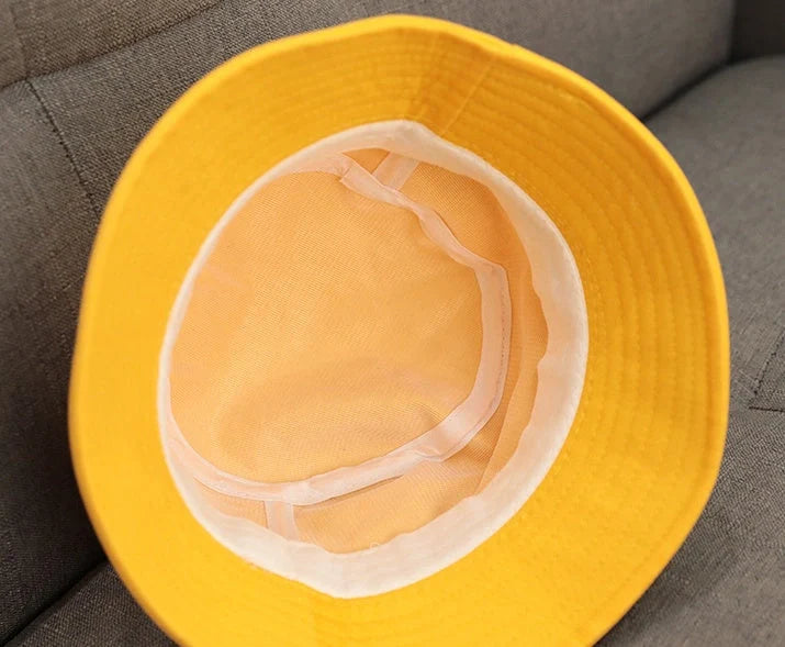 Child wearing anti-spitting protective hat with transparent bezel