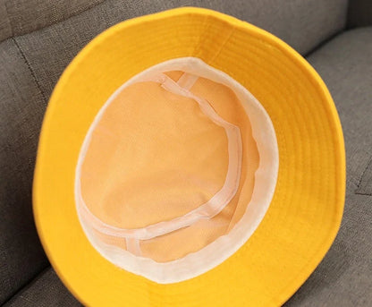 Child wearing anti-spitting protective hat with transparent bezel