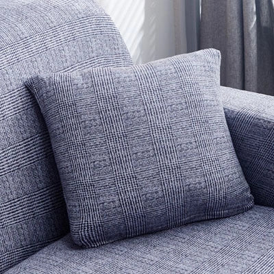Stretchable geometric print sofa cover on a three-seater sofa