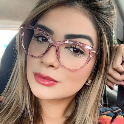 Women's anti-blue light cat eye glasses in transparent pink, bright black, transparent grey, and transparent tea