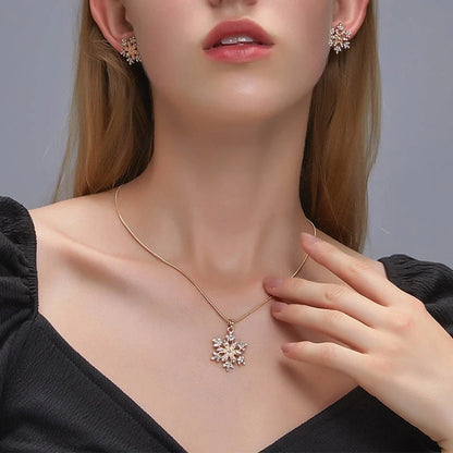 Elegant snowflake jewellery set with necklace, earrings and pendant in gold and silver tones