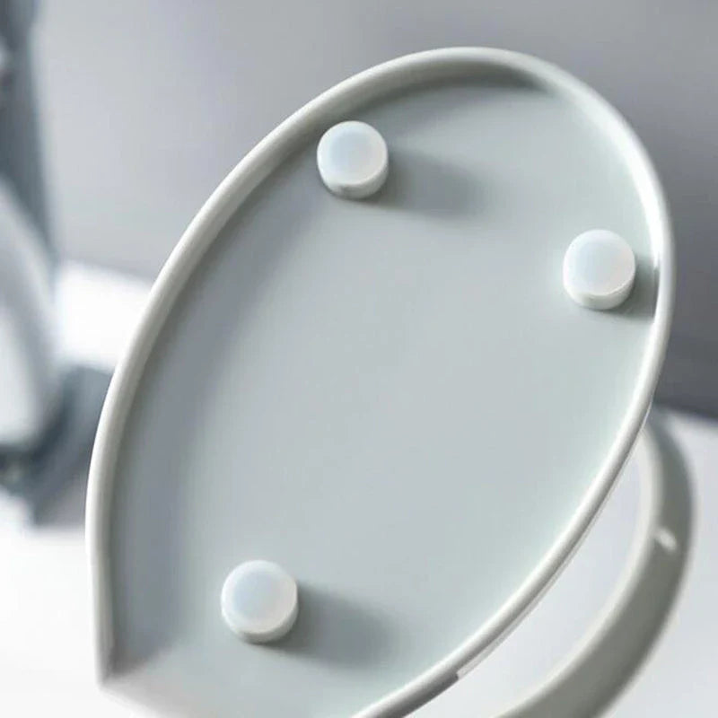 Elegant leaf-shaped soap dish with self-draining design and stable triangular shape, made of durable ABS material