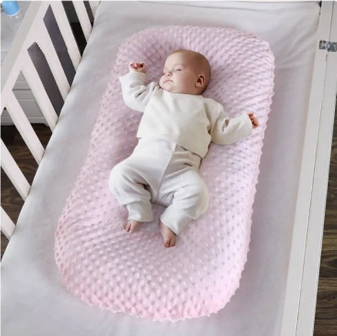 Newborn bionic nap bed in blue and yellow, designed for safety and comfort