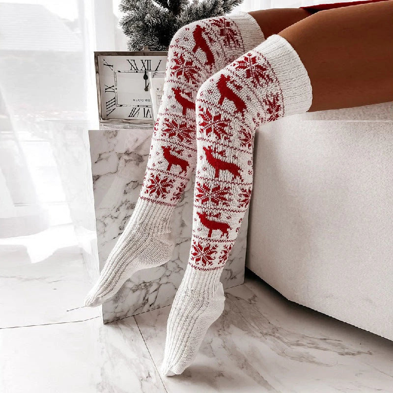 Cozy Christmas knee-high socks for women featuring a festive snowflake and reindeer pattern, designed to provide warmth and comfort during the winter season.