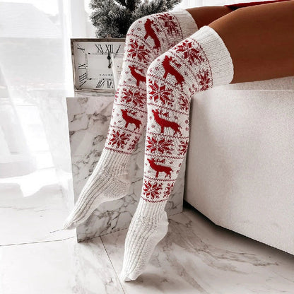 Cozy Christmas knee-high socks for women featuring a festive snowflake and reindeer pattern, designed to provide warmth and comfort during the winter season.