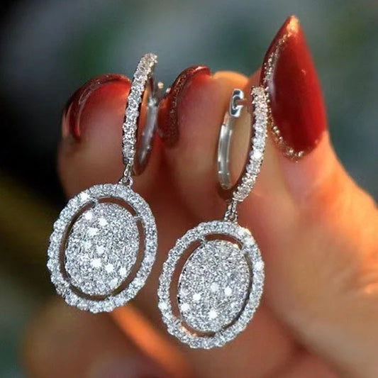 Elegant white gold plated oval earrings for women, perfect for any occasion.