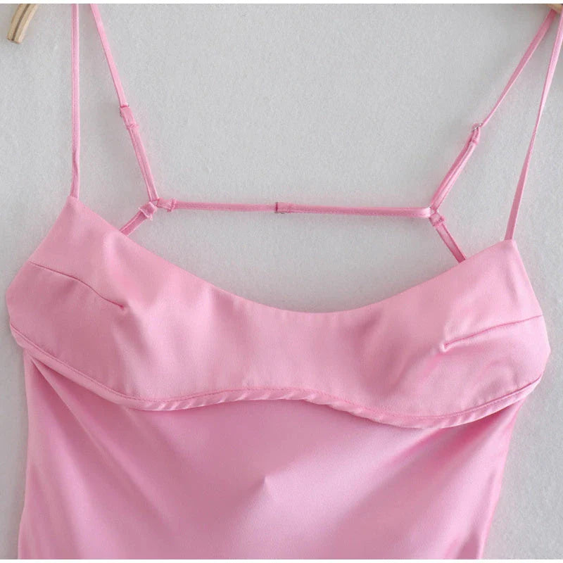 A sleek and elegant satin slip dress in a stunning pink color with a backless design and full-length silhouette.