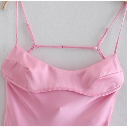 A sleek and elegant satin slip dress in a stunning pink color with a backless design and full-length silhouette.