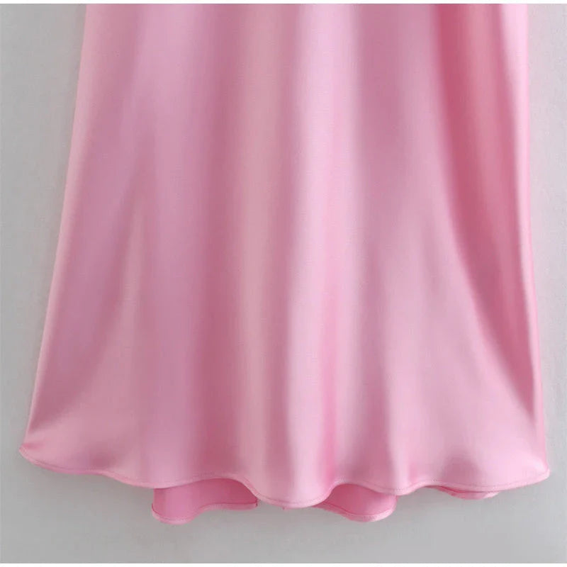 A sleek and elegant satin slip dress in a stunning pink color with a backless design and full-length silhouette.