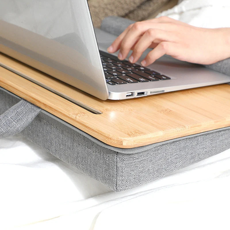 Elegant bamboo lap desk with cushioned surface and card slots for relaxing laptop use