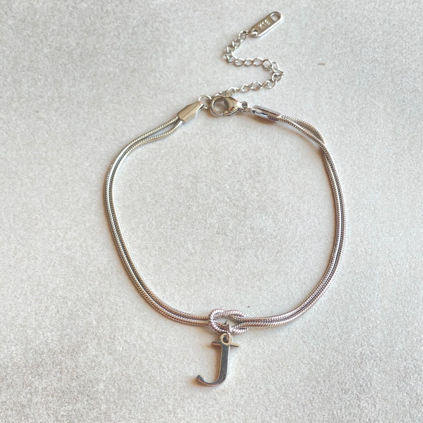 Personalised gold and silver love knot bracelets for couples, perfect as Valentine's Day gifts.