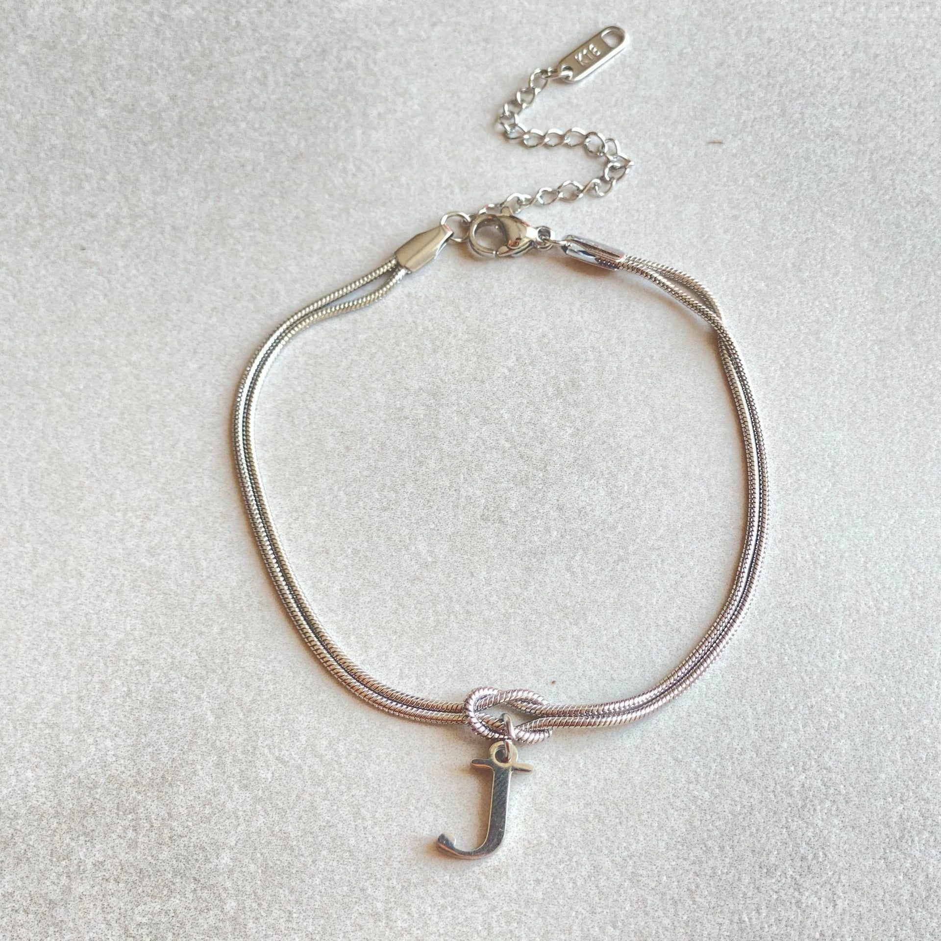 Personalised gold and silver love knot bracelets for couples, perfect as Valentine's Day gifts.