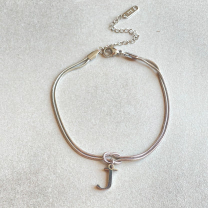 Personalised gold and silver love knot bracelets for couples, perfect as Valentine's Day gifts.