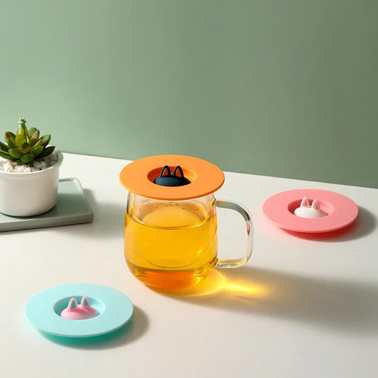 Spill-Proof Cat Ear Silicone Drink Lid in various colors, including pink, orange, and blue