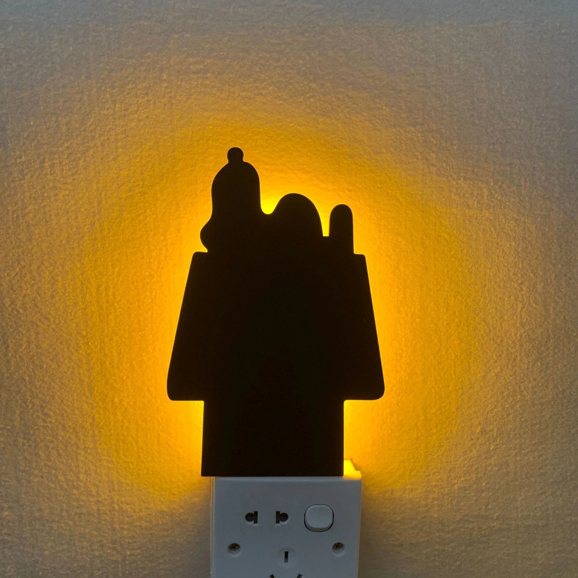 A stylish cat-shaped smart sensor night light that automatically illuminates a room when motion is detected, creating a warm and cozy atmosphere.