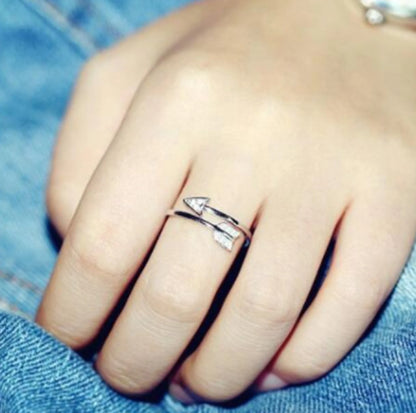 Copper arrow-shaped ring with a sleek, polished finish and a touch of subtle shimmer for a sophisticated, modern look.