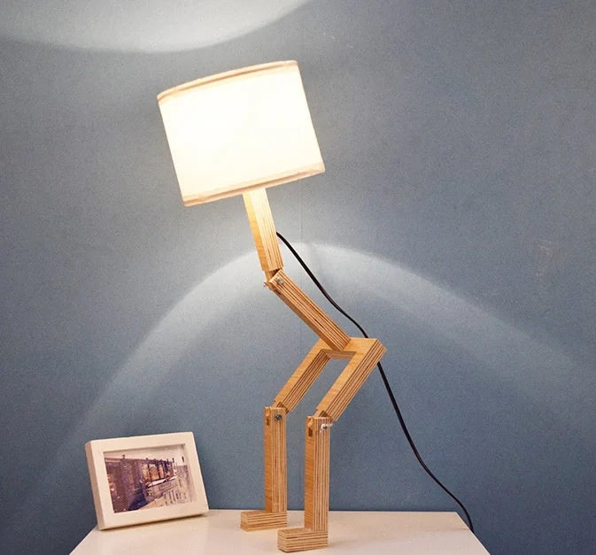 Humanoid table lamp with wooden base and white fabric shade, modern home decor