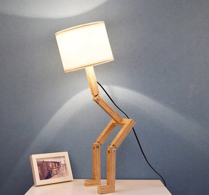 Humanoid table lamp with wooden base and white fabric shade, modern home decor